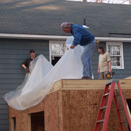 Putting down plastic for rain